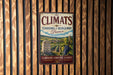 A vintage metal sign with the title "The Climats Terroirs of Burgundy France" displayed on a wooden wall.