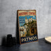 A vintage-style metal sign advertising "The Historic Centre Chora" in Greece, featuring a scenic image of a Greek island with white buildings and a cave.