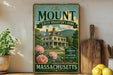a vintage-style sign for Edith Wharton's home in Massachusetts, with a large illustration of the house surrounded by flowers and greenery.