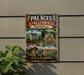 a vintage metal sign with illustrations of various landmarks and buildings, including the Palaces of King Ludwig II in Bavaria, Germany.