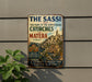 a vintage metal sign with a picture of a cityscape and text, mounted on a wall next to a plant.