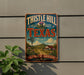 A vintage-style metal sign with the text "THISTLE HILL TEXAS" and a scenic illustration of a rural landscape with a windmill, house, and flowers.
