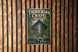 A vintage metal sign for the "Thorncrown Chapel" in Arkansas, featuring an illustration of the chapel's interior.