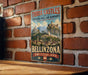 A vintage-style sign for "Three Castles and Defensive Wall and Ramparts of the Market-Town of Bellinzona, Switzerland" is displayed on a brick wall.