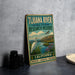 A vintage-style metal sign for the Tijuana River National Estuarine Research Reserve in California, featuring a white egret and a scenic landscape.