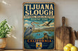 A vintage-style sign for the National Wildlife Refuge in California, featuring illustrations of various birds and marine life.