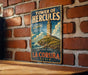 A vintage metal sign for the Tower of Hercules, a historic landmark in La Coruna, Spain.