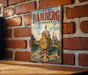 A vintage metal sign for the town of Bambberg, Germany, featuring a castle and a river, mounted on a brick wall.
