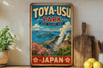 A vintage-style sign for Toya-USU Park, featuring a scenic landscape with mountains, water, and flowers, along with the text "JAPAN" and "TOYA-USU PARK NATURE VOLCANoes E beauty".