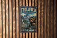 A metal sign with a cartoon image of a troll in a park, with a mountain landscape in the background.
