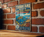A vintage-style sign for Tubbataha Reefs Natural Park in the Philippines, featuring an illustration of a sea turtle swimming among colorful fish and coral.
