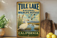 A vintage-style metal sign for Tule Lake National Wildlife Refuge in California, featuring an illustration of a duck and a mountain landscape.