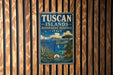 A vintage-style metal sign with the text "TUSCAN ISLANDS BIOSPHERE RESERVE ITALY" is displayed on a wooden wall.