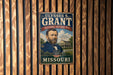 A vintage-style metal sign featuring a portrait of a man, with text that reads "Ulysses S. Grant" and "Missouri".
