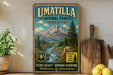 A vintage-style sign for the Umatilla National Forest in Oregon, featuring a mountain landscape and a river, with text promoting outdoor adventure and wilderness for generations.