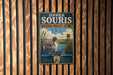 A vintage metal sign for the Upper Souris National Wildlife Refuge, featuring a duck and a bird in a grassy field with a tower in the background.