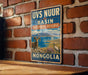 a vintage-style sign for the UVS Nuur Basin Biosphere Reserve in Mongolia, with a mountain landscape and two animals, a ram and a crane, depicted on the sign.