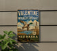 A vintage-style metal sign for the Nebraska Wildlife Refuge, featuring a duck in flight and a scenic landscape.