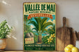 a vintage-style sign for the Vallee de Mai Nature Reserve in Seychelles, with a tropical island landscape and palm trees depicted.