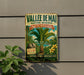 a vintage-style sign for the Vallee de Mai Nature Reserve in Seychelles, depicting a tropical landscape with palm trees, coconuts, and other natural elements.