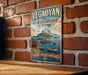 A vintage metal sign with the text "VEGA ARCHIPELAGO NORWAY" and an illustration of a coastal landscape with boats and mountains.