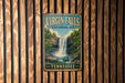 A vintage-style metal sign for Virgin Falls, a state natural area in Tennessee, is displayed on a wooden wall.