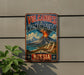 A vintage-style metal sign with the text "VOLCANoes of Kamchatka" and "RUSSIA" on it, depicting a volcano with smoke and clouds.