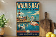 A vintage-style metal sign for Walvis Bay, Namibia, featuring a pink flamingo, a lighthouse, and a coastal town.