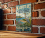 A vintage metal sign for Waquoit Bay National Estuarine Research Reserve, featuring a seagull and a scenic landscape.