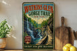 A vintage-style metal sign for Watkins Glen Gorge Trail in New York, featuring a scenic waterfall and lush greenery.