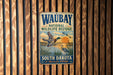 A vintage metal sign for the Waubay National Wildlife Refuge in South Dakota, featuring an illustration of ducks and a sunset.