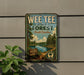 A vintage-style metal sign for WEE TEE STATE FOREST, South Carolina, featuring a scenic landscape with a lake and trees.