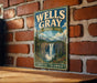 A vintage-style metal sign for Wells Gray, a scenic mountain park in British Columbia, Canada.