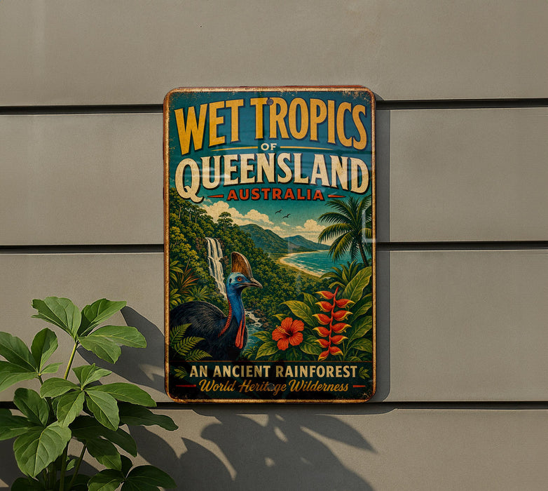 A vintage-style sign advertising the Wet Tropics of Queensland, Australia, featuring a colorful illustration of a tropical landscape with a bird, palm trees, and flowers.