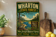 A vintage-style sign for Wharton State Forest in New Jersey, featuring a scenic illustration of a river, pine trees, and wildlife.
