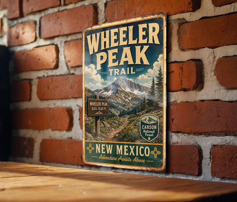 A vintage metal sign for Wheeler Peak Trail in New Mexico, featuring a mountain landscape and trail information.