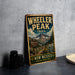A vintage metal sign for Wheeler Peak Trail in New Mexico, featuring a mountain landscape and trail sign.