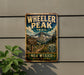 A vintage-style metal sign for Wheeler Peak Trail in New Mexico, featuring a mountain landscape and trail marker.