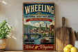 A vintage-style metal sign for the Wheelling National Heritage Area, featuring an illustration of a cityscape with a river and a bridge.