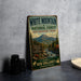 A vintage-style metal sign for White Mountain National Forest in New Hampshire and Maine, featuring a scenic mountain landscape and inviting visitors to explore the area's natural beauty.