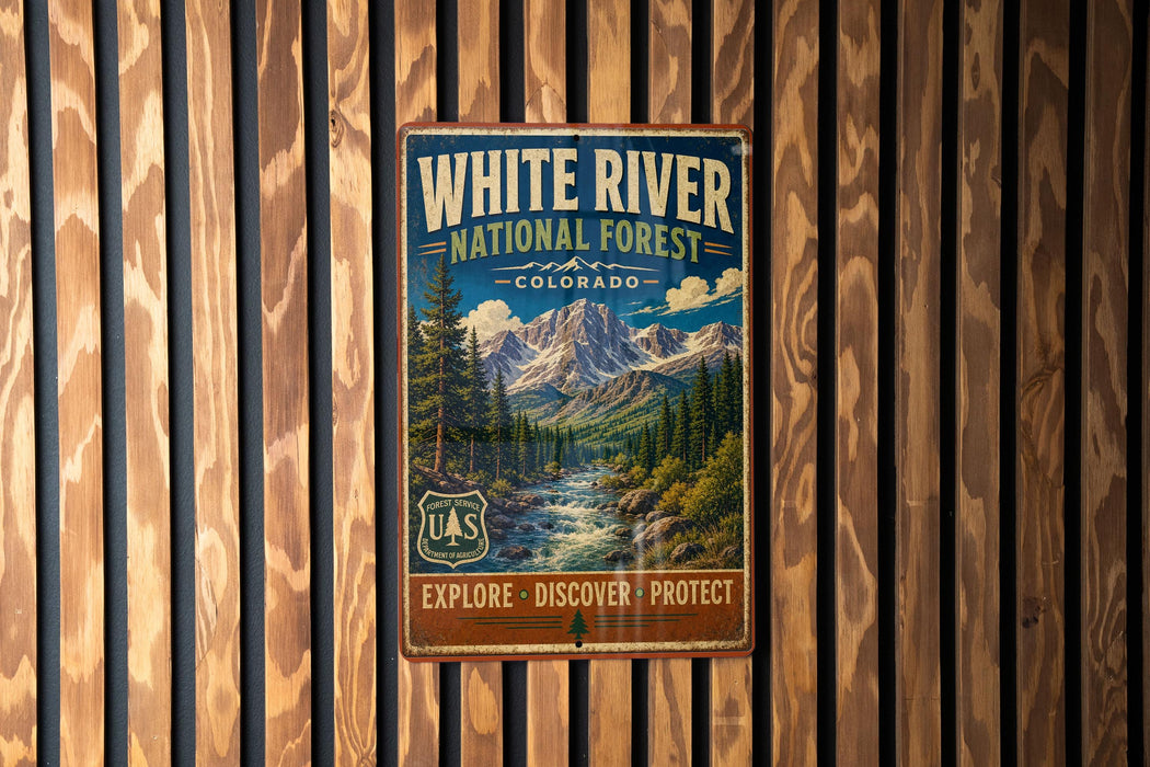 A vintage-style metal sign for the White River National Forest in Colorado, featuring a scenic mountain landscape and a river.