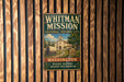 A vintage-style metal sign for the Whitman Mission, a historic site in Washington, with a picture of a building and a sign that says "Est 1836".