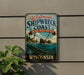 A vintage-style metal sign for the Wisconsin Shipwreck Coast, featuring a lighthouse and a shipwreck in the background.