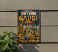 A vintage metal sign with the text "WORKS OF ANTONI GAUDI SPAIN ARCHITECTURE - ART - VISION" is displayed on a wall, with a plant visible to the left.