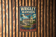 A vintage metal sign for Wrigley mansion in Catalina Island, California, featuring a colorful illustration of the mansion and palm trees.