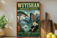 A vintage-style poster advertising the Wuyishan Biosphere Reserve in China, featuring a panda bear and a scenic landscape.