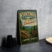 A vintage-style metal sign for Wyantenock State Forest in Connecticut, featuring a scenic landscape with pine trees and a river.