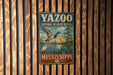 A vintage metal sign for the Yazoo National Wildlife Refuge in Mississippi, featuring a duck and a bird in a natural setting.