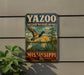 A vintage-style metal sign for the YAZOO NATIONAL WILDLIFE REFUGE in Mississippi, featuring a colorful illustration of a bird in flight and a serene landscape.