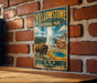 A vintage-style metal sign for Yellowstone National Park, featuring an illustration of a bison and the iconic geyser.
